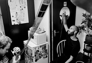 Youth inspecting their developed film negatives.