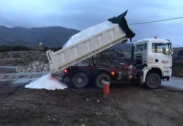 Truck unloading sand at construction site