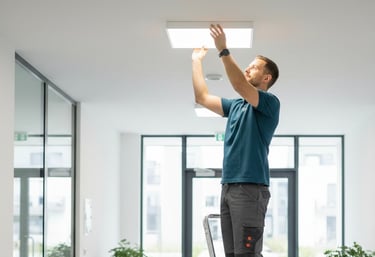 a man standing on a ladder ladder to reach the ceiling