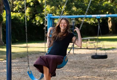 Tina Lilly, MS, LPC at play on a swing set