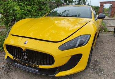 an Enlab yellow Maserati sports car parked in a driveway
