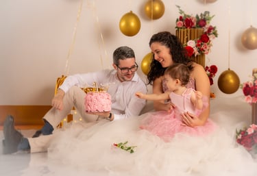 a man and woman sitting on a bed with a cake