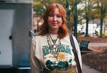 Young redheaded college woman smiling at camera.