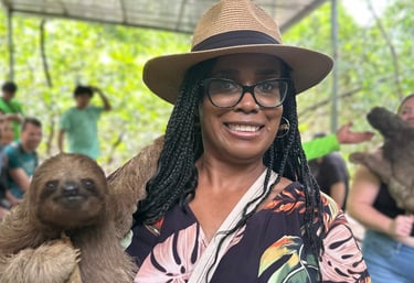 a woman in a hat and a hat holding a sloth - sloth slot