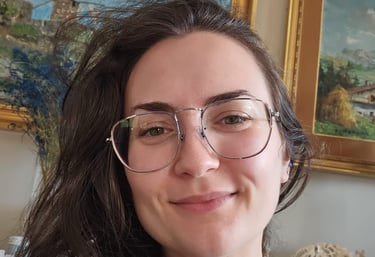 a woman with glasses and a white shirt