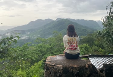 Girl on mountain watching the view at Ngoi
