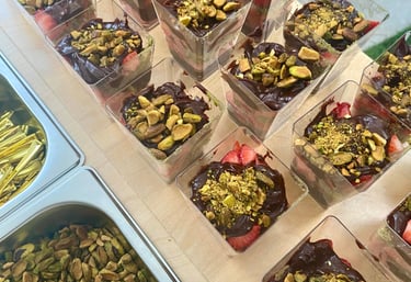 a table with chocolate Dubai strawberry cups desserts on it