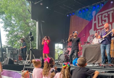 LuxeBand performing at an outdoor festival for an audience of children