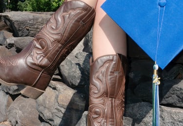 Cowboy boots and a graduation cap photo