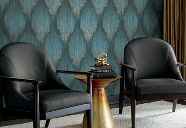 Modern living room featuring blue ikat textured wallpaper and two black leather armchairs.