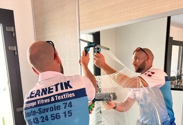 a man in a blue shirt cleaning mirror