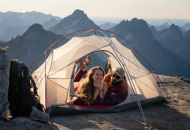 an adventurous couple sitting in a tent in the mountains