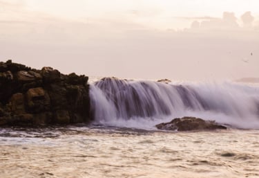water falling down rocks in the sea into rock pool