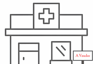 a hospital building with a sign that says to sell