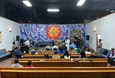 a group of people sitting in a church with a pulpit