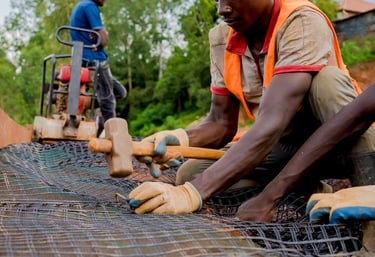 Close-up of geogrid reinforcement being installed for soil stabilization.