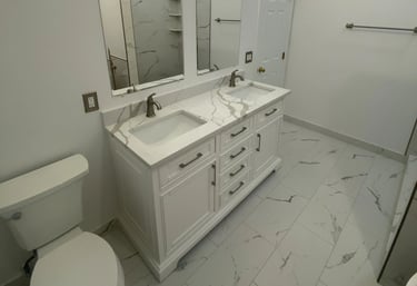 Modern bathroom with white double vanity and bronze faucets