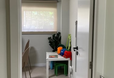 a hallway way with a table and chairs