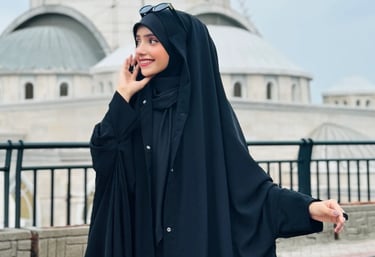 a woman in a black dress and a white hat