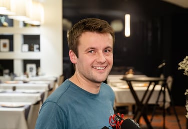 a man holding a camera and smiling