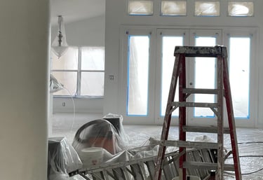 a man is painting a wall in a room