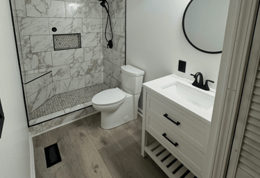 a bathroom with a marble shower and a marble shower