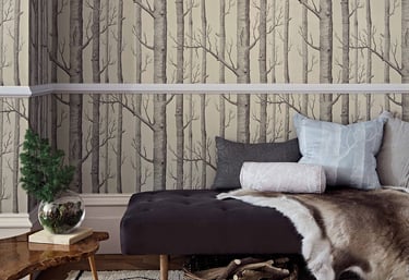 Rustic room featuring birch tree forest wallpaper with a daybed, fur rug, and gold deer head wall decor.