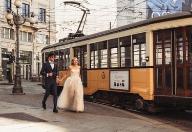 a bride and groom walking down the street in Milan