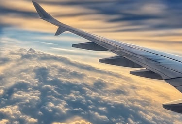 a view of the wing of an airplane as it flies over a mountain range