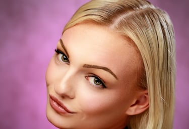 Over-the-shoulder portrait of a young lady with blonde hair and a black top