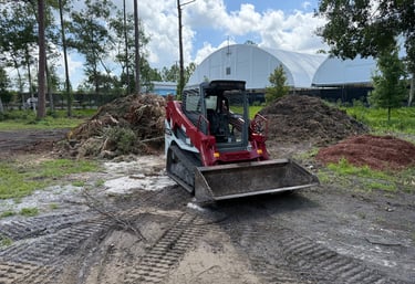 a tractor with a loader on a dirt road