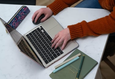 Wirral Brand designer working on brand identity project using MacBook