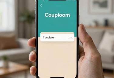 A high-quality smartphone held by a hand, showing the Couploom app interface with teal and sand colors, set against a soft North American home background.