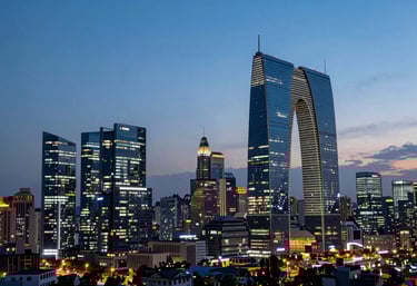 A panoramic twilight view of a Global Business city skyline, featuring modern architecture lit with deep navy blue and soft sky blue lights.