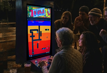 a group of older people playing Dig Dug on a Retro Arcade Game Slab.