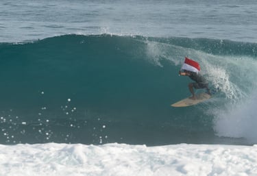 surfing dylans in simeulue holding indonesian flag - stay with the locally owned camps!