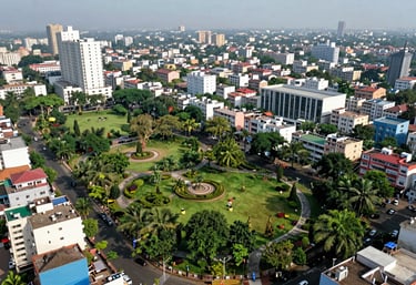 A high-angle view of a well-organized urban neighborhood in Noida, India, showing lush green parks and modern infrastructure.