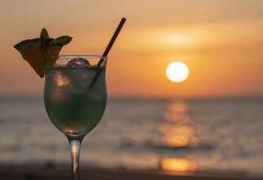 A cozy workspace with travel maps, a laptop, and a steaming cup of coffee.