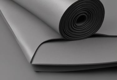 Close-up of NBR and EPDM rubber foam rolls stacked in a warehouse.