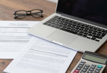 A professional consultant assisting a client with electronic invoicing on a laptop.