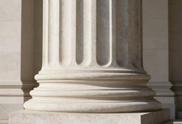 An abstract shot of a courthouse column in off-white stone, showing sharp shadows and minimalist composition.