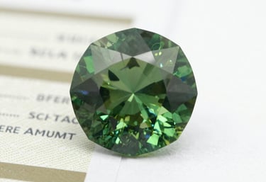 Elegant goldsmith tools arranged neatly beside a partially finished emerald necklace.