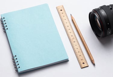 A flat lay photography of a mathematician's workspace in Bangladesh with a pale blue notebook, a wooden ruler, and a sharp pencil on a white surface. Clean, professional composition.