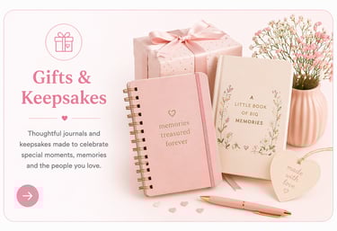 Pink memory journals and personalized gifts with a wrapped present and floral decorations for keepsakes.