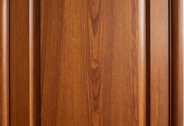 The elegant texture of a mahogany wood executive office door, North American / US design, warm gold and deep brown tones, soft side-lighting highlighting the wood grain and polished finish.