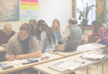 group of teachers at desks learning in a classroom