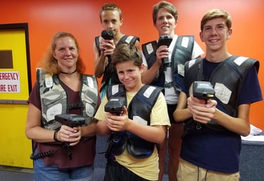 family posing for laser tag