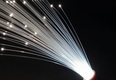 Abstract close-up of a high-speed fiber optic cable glowing with a soft white light in a dark environment. Technical and futuristic Turkish tech vibe.