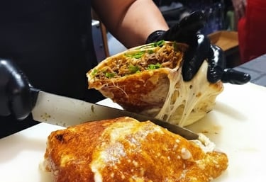 a person cutting a sandwich with a knife and knife