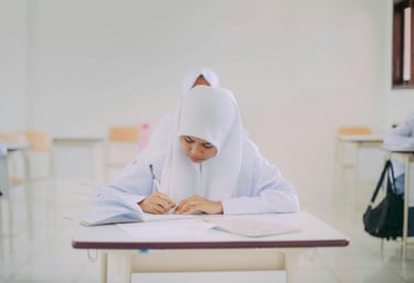 Malaysian student writing for SPM and UASA exam prep using visual learning for memory mastery with PNI Neuron.
